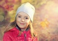 Happy smiling child outdoors on fall background. Royalty Free Stock Photo