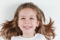 Happy smiling child portrait on the white background. Little todler attractive lovely curious cheerful girl laughs with her white