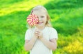 Happy smiling child with sweet caramel lollipop having fun