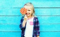 Happy smiling child with sweet lollipop having fun