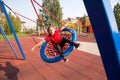 Happy smiling child swinging on a swing with closed eyes and arms outstretched at playground Royalty Free Stock Photo