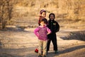 Happy smiling children walking about the country road. Tajikistan. Dushanbe. 11.12.2010