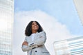 Happy young African American business woman standing in city feeling proud. Royalty Free Stock Photo