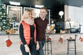 Happy smiling couple embracing in coffee shop in winter season Royalty Free Stock Photo