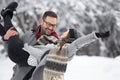 Man lifting girl in snow in forest Royalty Free Stock Photo