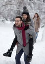 Man lifting girl in snow in forest Royalty Free Stock Photo