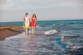 Happy smiling couple holding hands walking on beach Royalty Free Stock Photo