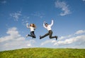 Happy smiling couple jumping in blue sky Royalty Free Stock Photo