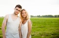 Happy Smiling Couple Relaxing on Green Grass. Royalty Free Stock Photo