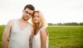 Happy Smiling Couple Relaxing on Green Grass. Royalty Free Stock Photo