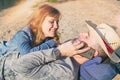 Happy Smiling Couple Relaxing on the sand. Man speaking on the p