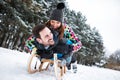 Happy smiling couple sledding