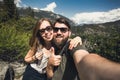 Happy smiling couple of students in love take selfie self-portrait while hiking in Yosemite National Park, California Royalty Free Stock Photo