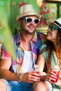 Happy smiling couple in sunglass and hat with guitar drinking j Royalty Free Stock Photo
