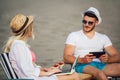 Happy smiling couple surfing the net and enjoy the summer at beach Royalty Free Stock Photo