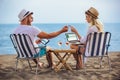 Happy smiling couple surfing the net and enjoy the summer at beach Royalty Free Stock Photo