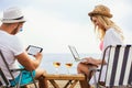 Happy smiling couple surfing the net and enjoy the summer at beach Royalty Free Stock Photo