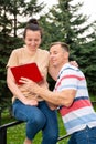 Happy smiling couple using a digital tablet outdoors Royalty Free Stock Photo