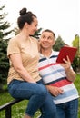 Happy smiling couple using a digital tablet outdoors Royalty Free Stock Photo