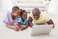 Happy smiling couple using laptop with their daughter Royalty Free Stock Photo