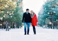 Happy smiling couple walking together, having fun in winter forest Royalty Free Stock Photo