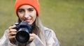 Happy smiling cute girl with camera. Young woman takes photo outdoors. Hobby. Photographer Royalty Free Stock Photo