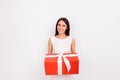 Happy smiling cute woman holding big red present box on white ba Royalty Free Stock Photo