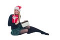 Woman sitting with Christmas hat and present in isolated background Royalty Free Stock Photo