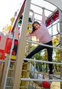 Happy smiling cutu little girl child on playground equipment Royalty Free Stock Photo