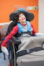 Happy, smiling disabled boy in wheelchair waiting in doctor's of Royalty Free Stock Photo