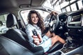 Happy smiling driver woman showing car key sitting in new auto Royalty Free Stock Photo