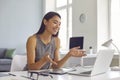 Happy young Asian woman sitting at desk at home and using laptop computer for video call Royalty Free Stock Photo