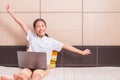 Happy smiling and excited asian girl using computer laptop notebook Royalty Free Stock Photo