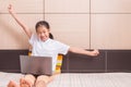 Happy smiling and excited asian girl using computer laptop notebook Royalty Free Stock Photo