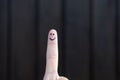 Happy smiling face hand drawn on a finger tip Royalty Free Stock Photo