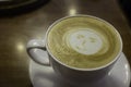 Happy smiling face milk foam design hot cappuccino coffee