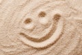 Happy smiling face in the sand macro photo