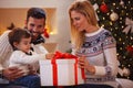 Happy family celebrating Christmas at home. father and mother gi Royalty Free Stock Photo