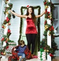 Happy smiling family on Christmas at house with gifts, young mother and little son in Santas red hat, lifestyle holiday