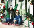 Happy smiling family on Christmas at house with gifts, young mother and little son in Santas red hat, lifestyle holiday