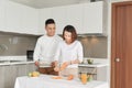 Happy smiling family couple cooking on loft kitchen