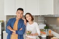 Happy smiling family couple cooking on loft kitchen