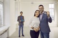 Happy, smiling family couple showing key to house or apartment that they are buying Royalty Free Stock Photo