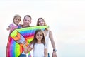 Happy smiling family with flying a kite on the beach Royalty Free Stock Photo