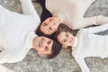 Top view.Happy smiling family hugging while lying on the floor in the room at home. C Royalty Free Stock Photo