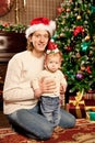 Happy smiling family near the Christmas tree celebrate New Year.