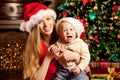 Happy smiling family near the Christmas tree celebrate New Year. Royalty Free Stock Photo