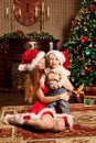 Happy smiling family near the Christmas tree celebrate New Year. Royalty Free Stock Photo