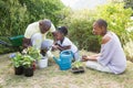 Happy smiling family plant a flowers together Royalty Free Stock Photo