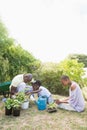 Happy smiling family plant a flowers together Royalty Free Stock Photo